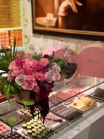 Элегантная композиция из роз и гиацинтов в сезоне Couture на фоне шоколадных сладостей.