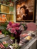 Элегантная композиция из цветов и тыквы Couture на фоне сладостей.