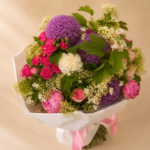 Close-up of vibrant seasonal flowers and exotic accents in the Peacock Bouquet