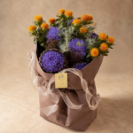 Close-up of purple artichokes, thistles and golden safflower in an exotic bouquet