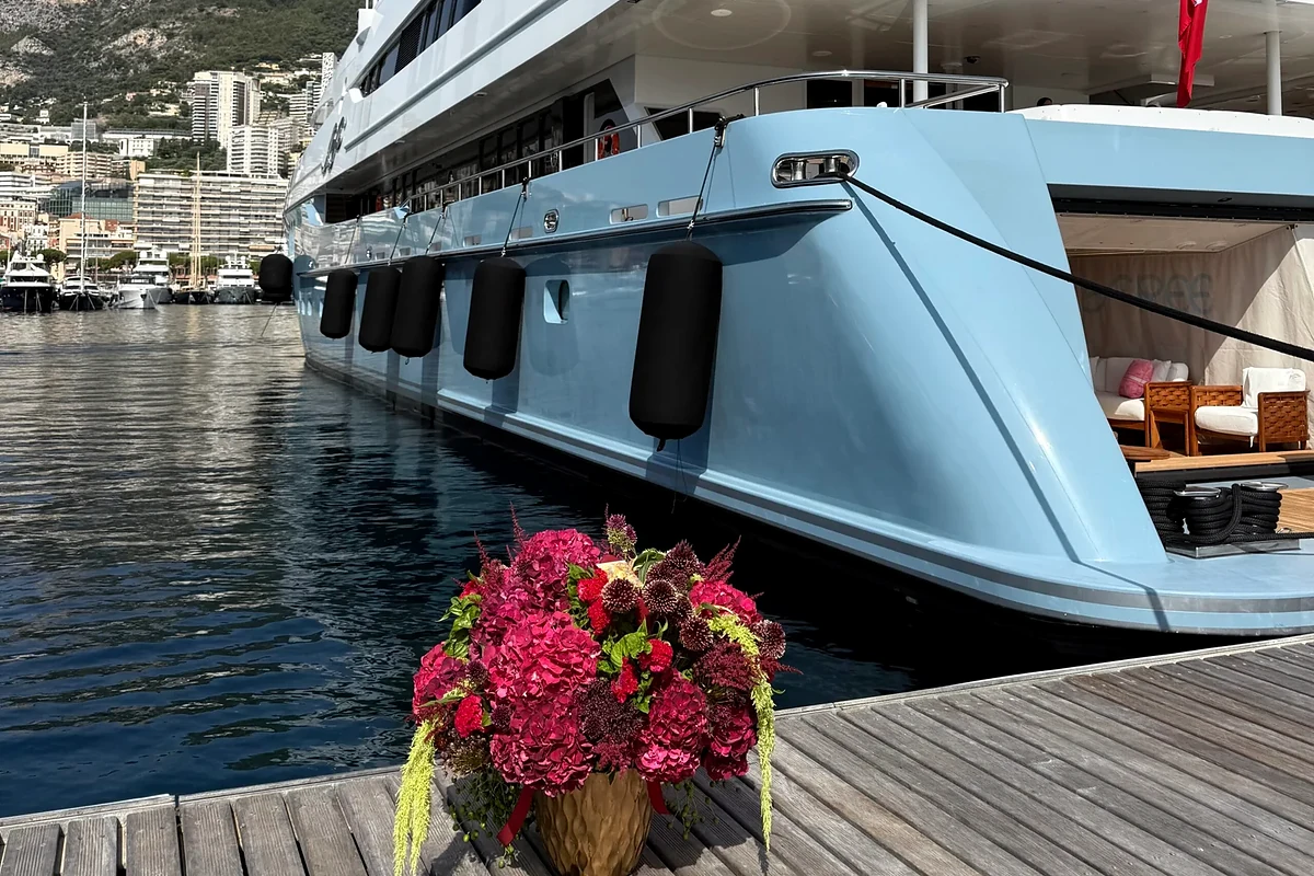 Yacht flowers Monaco beside a superyacht in Port Hercules