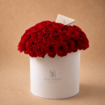 L’Amour Rouge arrangement of 101 premium Red Naomi roses in a white couture flower box